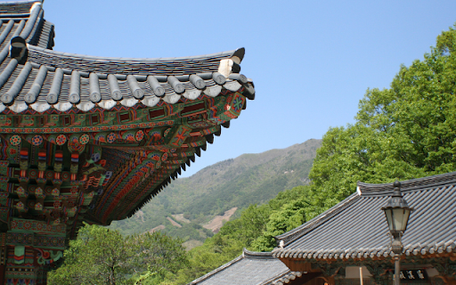 Intricate Temple Roofs Amidst Mountainous Terrain  from Chrome web store to be run with OffiDocs Chromium online