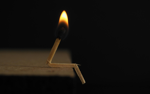 Lighted Matchstick on Brown Wooden Surface  from Chrome web store to be run with OffiDocs Chromium online