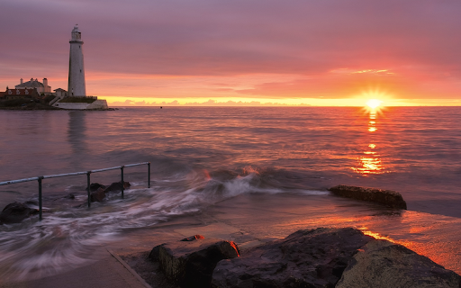 Lighthouse with sun on the sea  from Chrome web store to be run with OffiDocs Chromium online