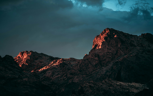 Low angle Photography of Rock Mountain Under Cloudy Sky  from Chrome web store to be run with OffiDocs Chromium online