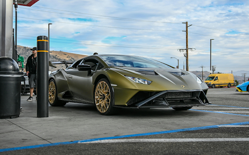 Luxury Olive Green Sports Car at a Gas Station  from Chrome web store to be run with OffiDocs Chromium online