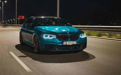 Man Driving a Blue BMW M5 on a Street  from Chrome web store to be run with OffiDocs Chromium online