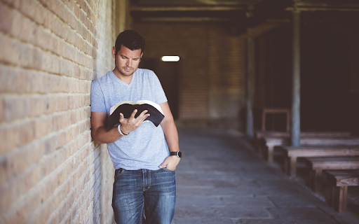 Man reading a book  from Chrome web store to be run with OffiDocs Chromium online