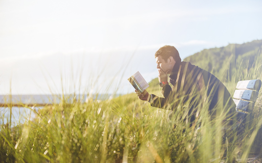 Man sitting reading a book  from Chrome web store to be run with OffiDocs Chromium online