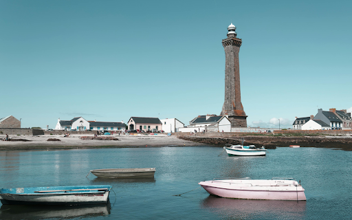 Penmarch Lighthouse with Boats in Brittany Harbor  from Chrome web store to be run with OffiDocs Chromium online