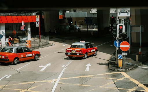 Red cars driving on street in city  from Chrome web store to be run with OffiDocs Chromium online