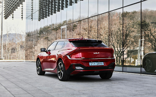 Red Kia EV6 by Windows of Modern Building  from Chrome web store to be run with OffiDocs Chromium online