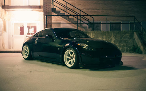 Shiny Car Parked Beside a Brick Building  from Chrome web store to be run with OffiDocs Chromium online