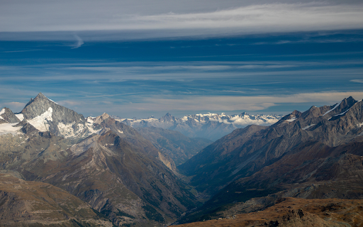 Snow Covered Mountains Under Blue Sky  from Chrome web store to be run with OffiDocs Chromium online