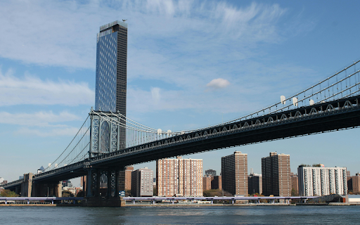 Suspension Bridge Over River in a City  from Chrome web store to be run with OffiDocs Chromium online