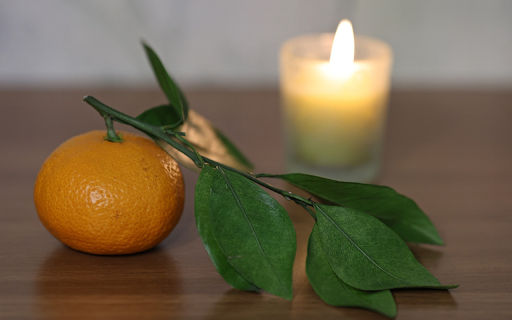 Tangerines next to scented candles  from Chrome web store to be run with OffiDocs Chromium online