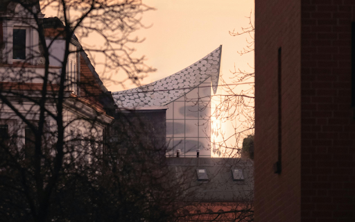 The sun is setting over a building with a large roof  from Chrome web store to be run with OffiDocs Chromium online