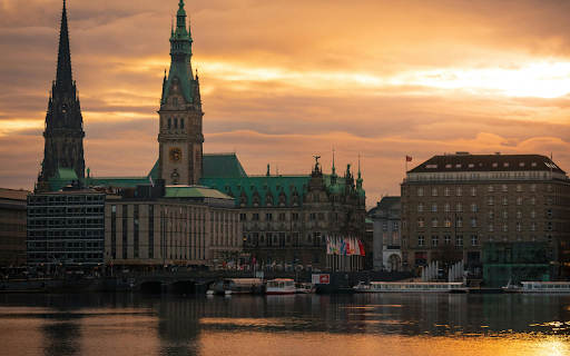 The sun sets over the water and buildings  from Chrome web store to be run with OffiDocs Chromium online