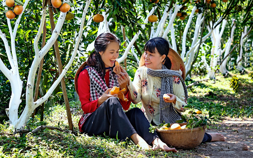 Two girls picking oranges  from Chrome web store to be run with OffiDocs Chromium online