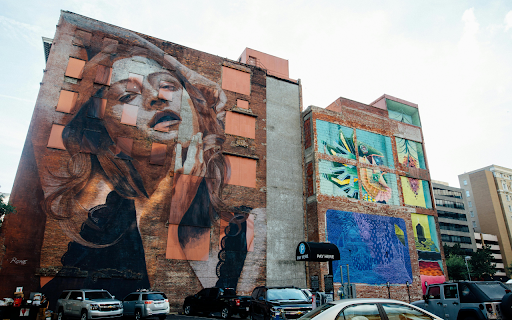 Vehicles Park Near Wall With Woman Graffiti  from Chrome web store to be run with OffiDocs Chromium online