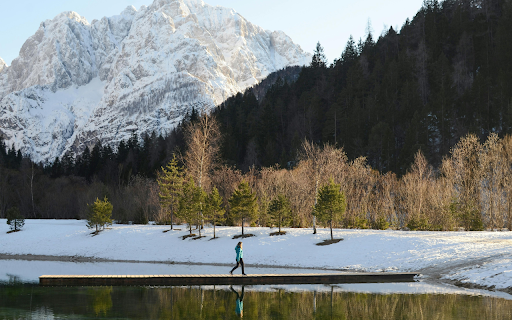 Woman Walking on a Pier on a Lake in a Valley  from Chrome web store to be run with OffiDocs Chromium online
