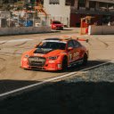 An Orang Audi RS 3 Racecar at a Racetrack  screen for extension Chrome web store in OffiDocs Chromium