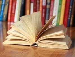 Free download book-on-the-desk-against-books free photo or picture to be edited with GIMP online image editor