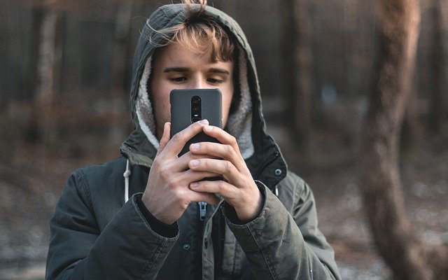 Free download boy man oneplus 6 phone forest free picture to be edited with GIMP free online image editor