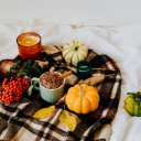 Brown Ceramic Mug and Pumpkins on a Checkered Fabric  screen for extension Chrome web store in OffiDocs Chromium