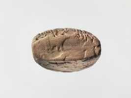 Free download Cuneiform tablet: administrative account of barley distribution with cylinder seal impression of a male figure, hunting dogs, and boars free photo or picture to be edited with GIMP online image editor