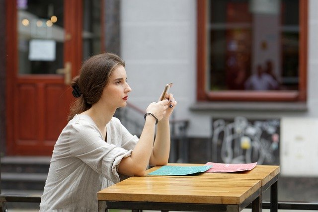 Free download girl phone table woman watching free picture to be edited with GIMP free online image editor