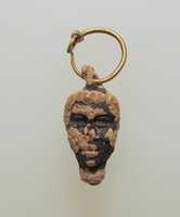 Free download Gold hoop with glass pendant in the form of a youthful head with negroid features free photo or picture to be edited with GIMP online image editor