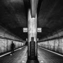 Grayscale Photo of a Person Standing on Subway Platform  screen for extension Chrome web store in OffiDocs Chromium