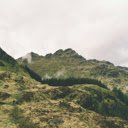 Green mountain under cloudy  screen for extension Chrome web store in OffiDocs Chromium