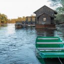 Green wooden boat on the river bank  screen for extension Chrome web store in OffiDocs Chromium