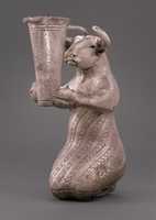 Free download Kneeling bull holding a spouted vessel free photo or picture to be edited with GIMP online image editor
