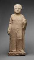 Free download Limestone statue of a male votary holding a dove and an apple free photo or picture to be edited with GIMP online image editor