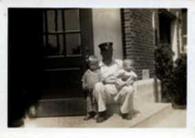Free download Metropolis Illinois fire chief Arnett sitting on front steps of City Hall - Fire Department with his 2 sons June 2, 1934 free photo or picture to be edited with GIMP online image editor