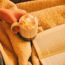 Person Holding Mug Filled With Pastry Beside Open book  screen for extension Chrome web store in OffiDocs Chromium