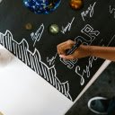 Person Writing on a Poster Using Black Marker  screen for extension Chrome web store in OffiDocs Chromium