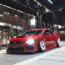 Red Subaru Parked in Front of Building  screen for extension Chrome web store in OffiDocs Chromium