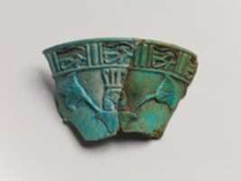 Free download Relief chalice rim fragment with a wedjat frieze and below that a Hathor sistrum head emerging from papyrus plants free photo or picture to be edited with GIMP online image editor