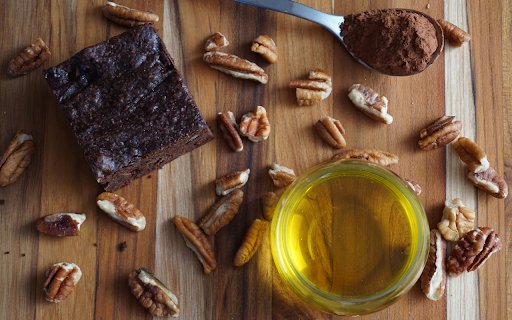 A brownie with nuts and chocolate on a cutting board  from Chrome web store to be run with OffiDocs Chromium online