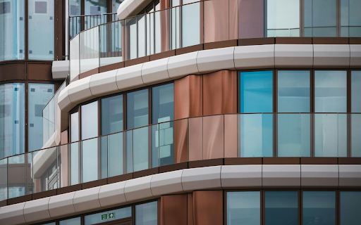 A building with glass windows and balconies  from Chrome web store to be run with OffiDocs Chromium online