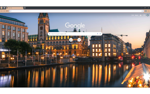 A city with a river and buildings at night  from Chrome web store to be run with OffiDocs Chromium online