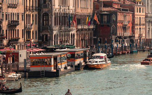 A gondola is floating down a canal in venice  from Chrome web store to be run with OffiDocs Chromium online
