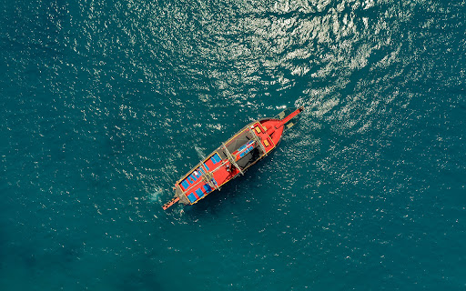 A graceful sailboat glides across the calm  from Chrome web store to be run with OffiDocs Chromium online