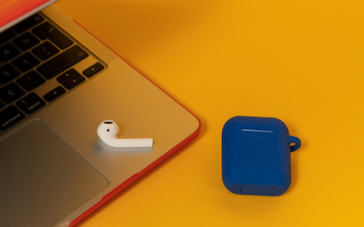 AirPods 2 in a Navy Blue Case on a Yellow Background Beside a Laptop  from Chrome web store to be run with OffiDocs Chromium online