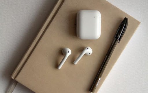 AirPods 2 Resting on a Notebook Beside a Pen  from Chrome web store to be run with OffiDocs Chromium online