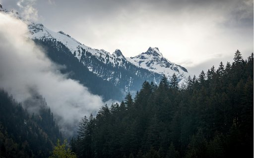 A mountain range with trees and clouds in the background  from Chrome web store to be run with OffiDocs Chromium online