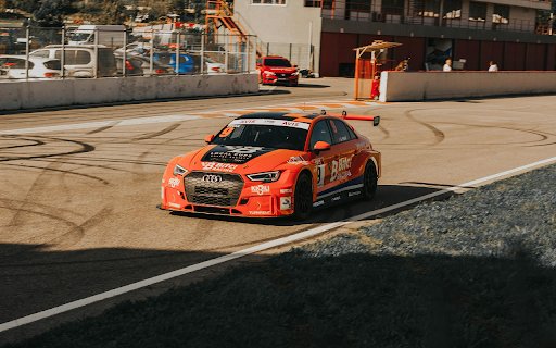 An Orang Audi RS 3 Racecar at a Racetrack  from Chrome web store to be run with OffiDocs Chromium online