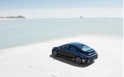 Drone Shot of a Hyundai Ioniq 6 by the Seaside  from Chrome web store to be run with OffiDocs Chromium online