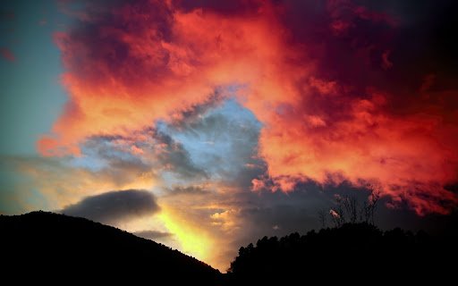 Fiery Sunset Over Mountain Silhouette  from Chrome web store to be run with OffiDocs Chromium online