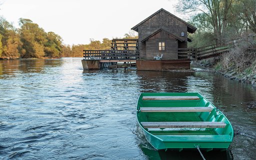 Green wooden boat on the river bank  from Chrome web store to be run with OffiDocs Chromium online