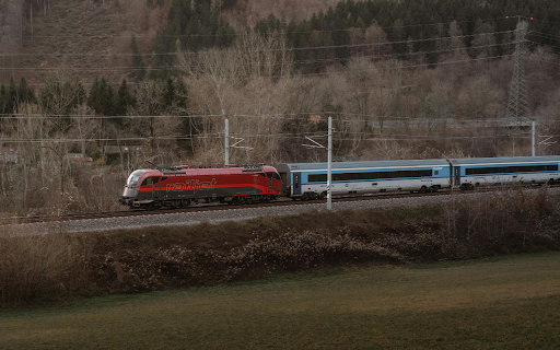 Red Railjet Train Traversing Scenic Mountainous Landscape  from Chrome web store to be run with OffiDocs Chromium online